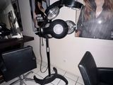 a picture of a salon with a chair and a hair dryer