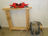 a picture of a fire hydrant and a hose on a stand