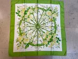 green and white square scarf with white flowers and leaves