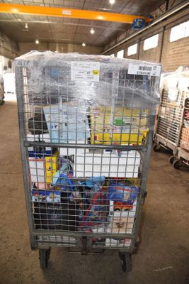 a metal cart with many items in it in a warehouse