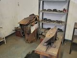 a wooden bench in the middle of a room with a shelf full of shoes