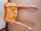 a wooden chair that is hanging on the wall