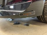 a close up of a car ' s bumper with a sticker on it