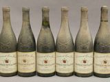 six bouteilles de vin sont alignées dans une rangée
