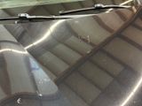 a close up of a car ' s windshield with a reflection of a building