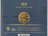 the back cover of a book with a gold coin on it