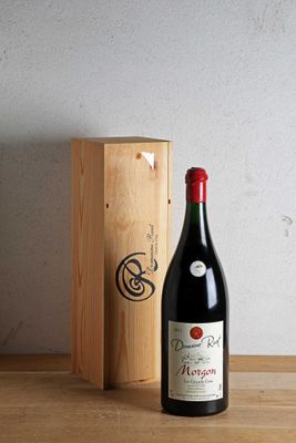 a bottle of wine sitting next to a wooden box