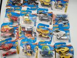 il y a plein de petites voitures Hot Wheels sur la table