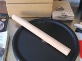 a black pan with a wooden handle sitting on a table