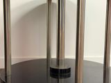 an image of a black and chrome coffee table on wheels