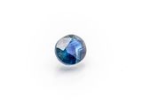 a close up of a blue sapphire stone on a white surface