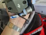 a person holding a video camera in a backpack