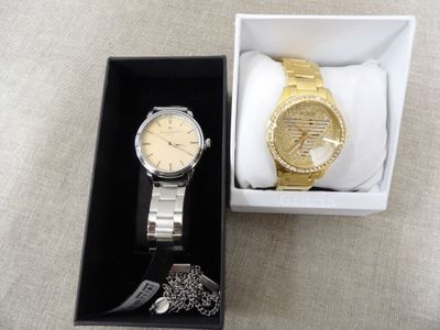 a watch and a bracelet in a box on a table