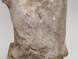 a close up of a stone statue of a head on a white surface