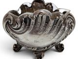 an image of a silver bowl sitting on top of a white surface
