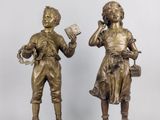 pair of antique bronze figurines of a boy and a girl