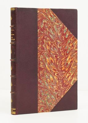 an old book with a red cover and a gold and red design