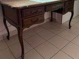 a desk with a computer on top of it in a room