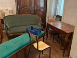 a room with a couch, chair, table, and other furniture in it