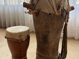 a large wooden drum and a small wooden drum on the floor