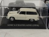 a small white car in a clear case on a table