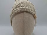 knitted hat with pom pom on top of a mannequin head