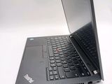 a laptop that is open on a white surface