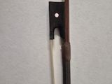 a bow and a stick on a white surface