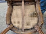 a close up of a wooden chair on a sidewalk