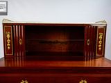a wooden dresser with a mirror on top of it