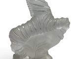 crystal figurine of a horse on a stand on a white background