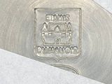 a close up of a knife with a stamp on it