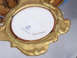 a gold frame with a picture of a bird on it