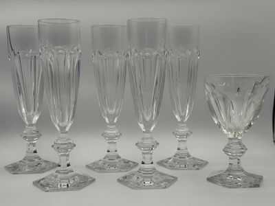 six clear wine glasses and a wine glass on a table