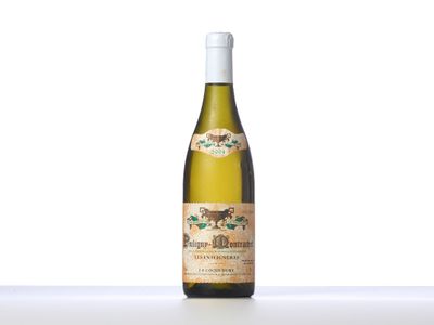 a bottle of white wine sitting on top of a table
