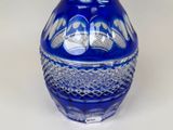 a blue glass vase with a decorative design on it
