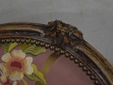a close up of a chair with a floral design on it
