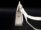 an image of a white handbag on a black background