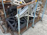 a pile of wood on a pallet in front of a building