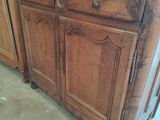 a wooden cabinet with a mirror on top of it