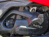 a close up of a red motorcycle with a chain attached to it