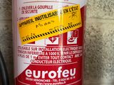 a red fire extinguisor sitting on a counter