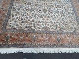 a large rug on the floor with a cat on it