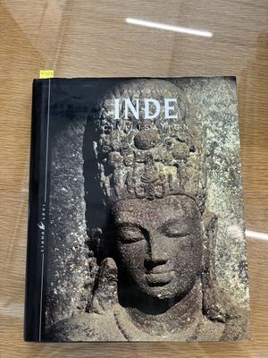 the book is sitting on the table in front of a glass case