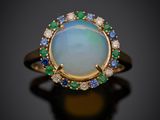 une bague sertie d'un oplite, d'un saphir, d'une émeraude et de diamants