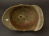a metal bowl with a hole in it on a black surface