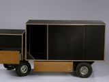 a toy truck that has a cabinet on the back of it