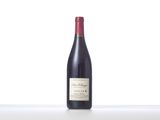 a bottle of red wine sitting on top of a white table
