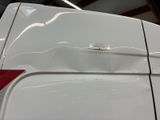a close up of a white car with a sticker on it