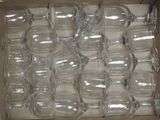 many empty wine glasses in a box on the table